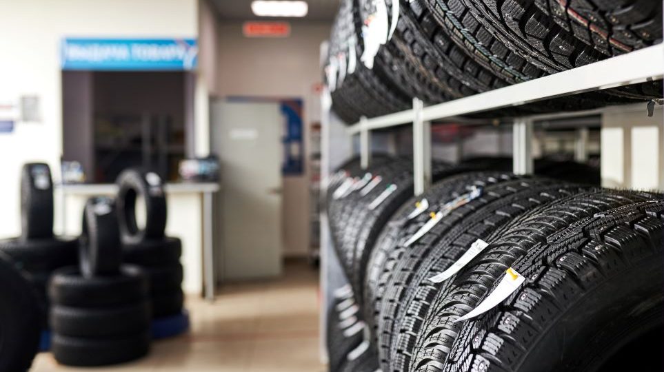 Tires on shelves in an automotive franchise store.