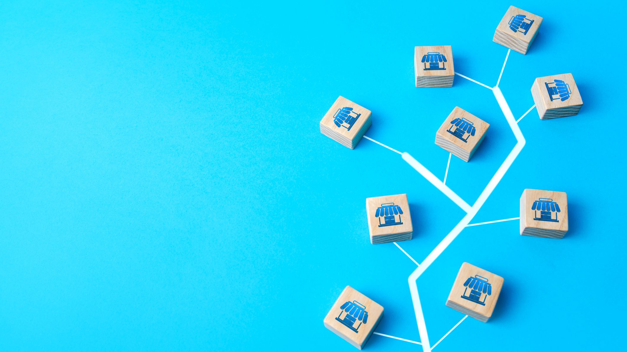 A tree made of wooden cubes on a blue background stands out.