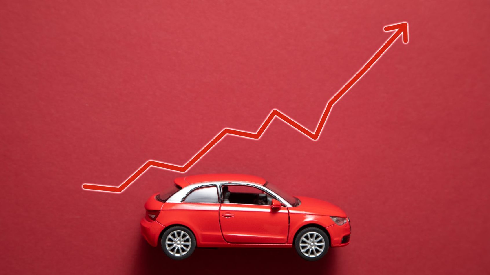 A red car on a red background with a graph of tire and automotive franchise.