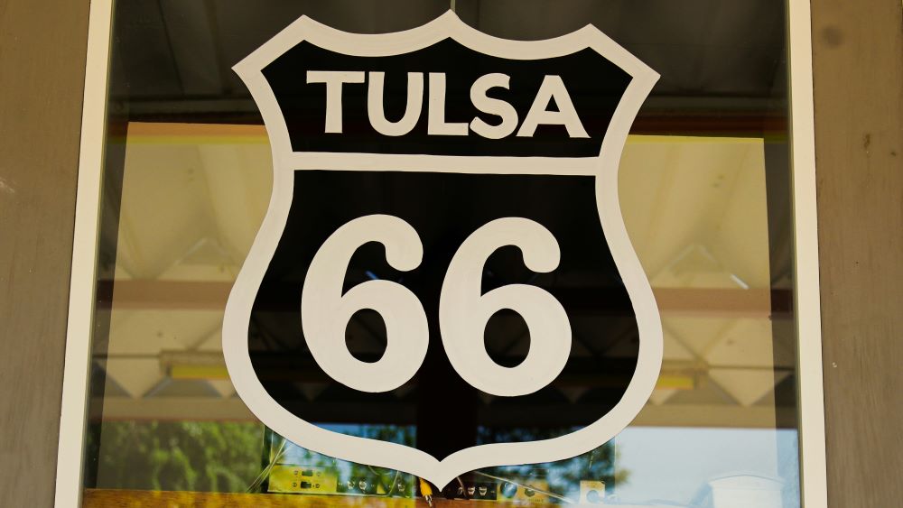 Sign displaying "tulsa 66" in a shield-shaped design, likely referencing auto repair in Tulsa along Route 66.