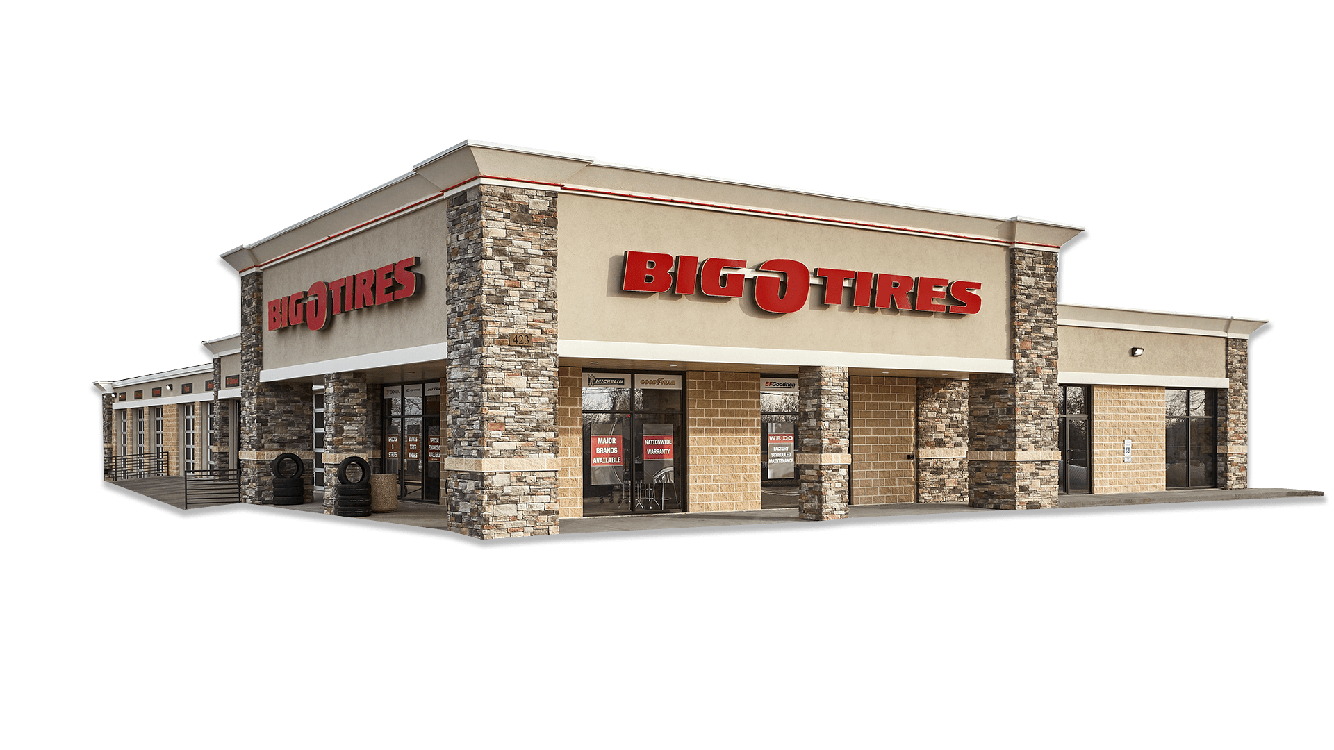A big o'fitness store with a sign on the front, also serving as a tire and automotive franchise.